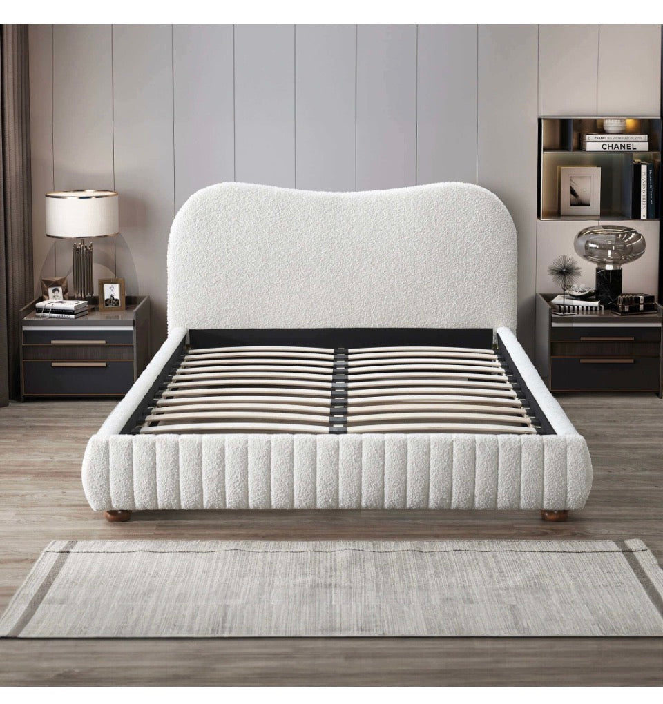 Cream boucle bed frame styled in bedroom with pillows