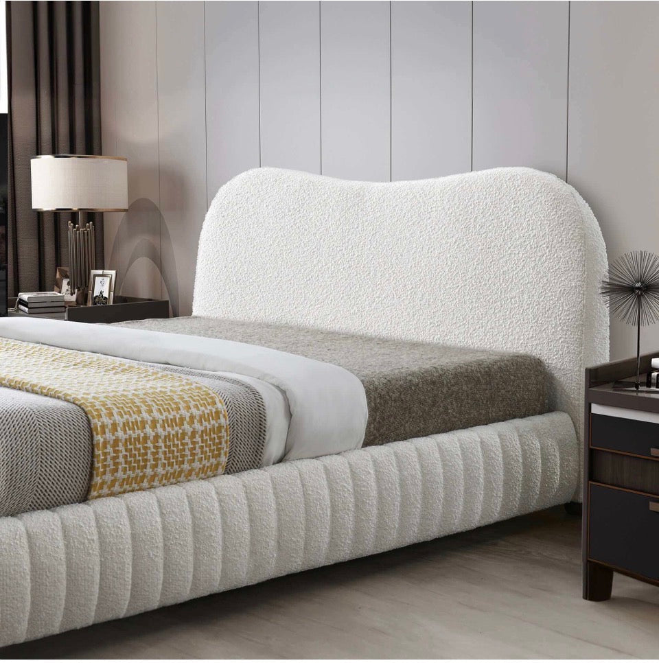 Cream boucle bed frame without mattress showing slat system