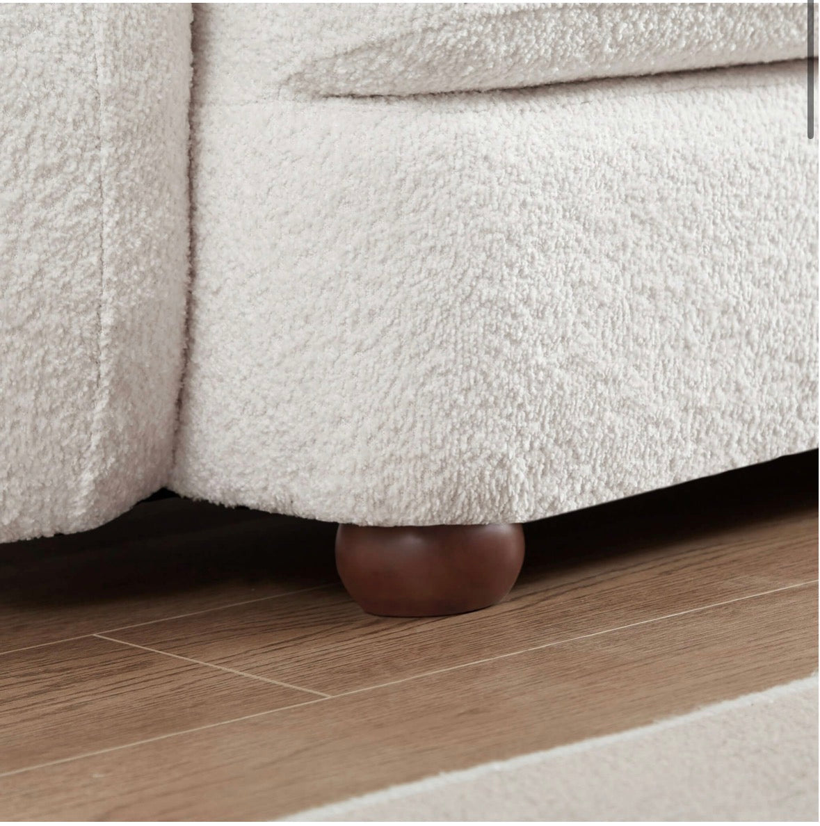 The Marlowe bouclé sofa – walnut ball foot detail