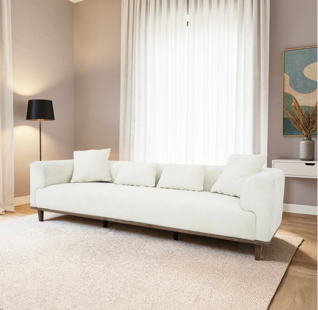 Claire Cream Velvet Sofa - side profile in neutral room