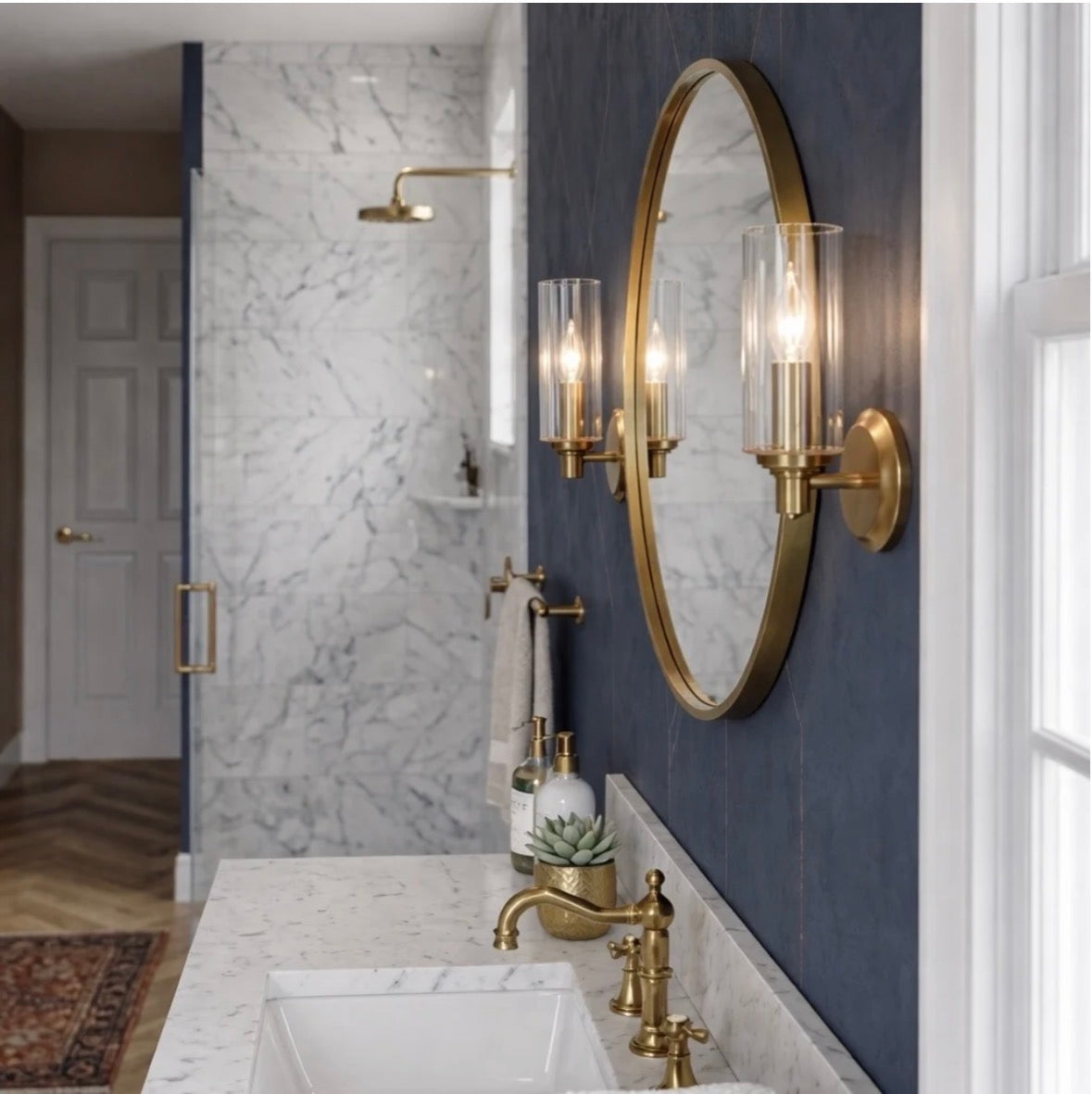 The Aurelia wall sconces flanking a round mirror in a luxury bathroom