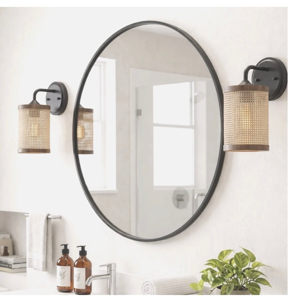 The Isla wall sconces flanking a round mirror in a bathroom