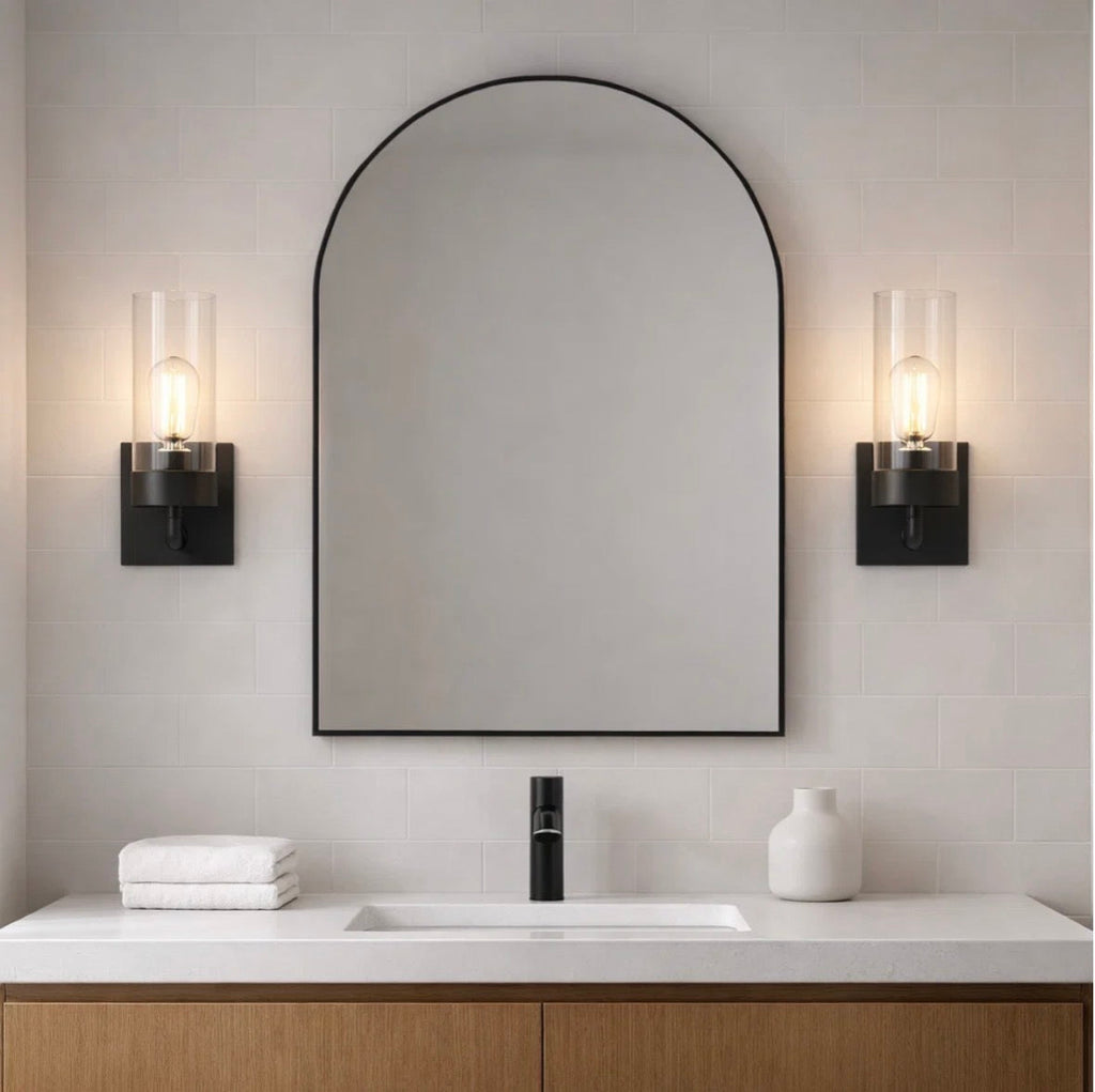 The Zephyr wall sconces flanking an arched mirror in a bathroom – lit