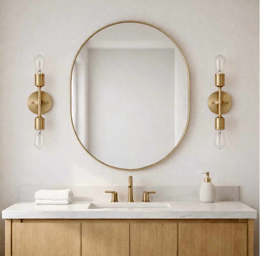 The Aurelia satin brass double-light sconce product shot on white subway tile