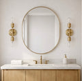 The Aurelia satin brass double-light sconce product shot on white subway tile