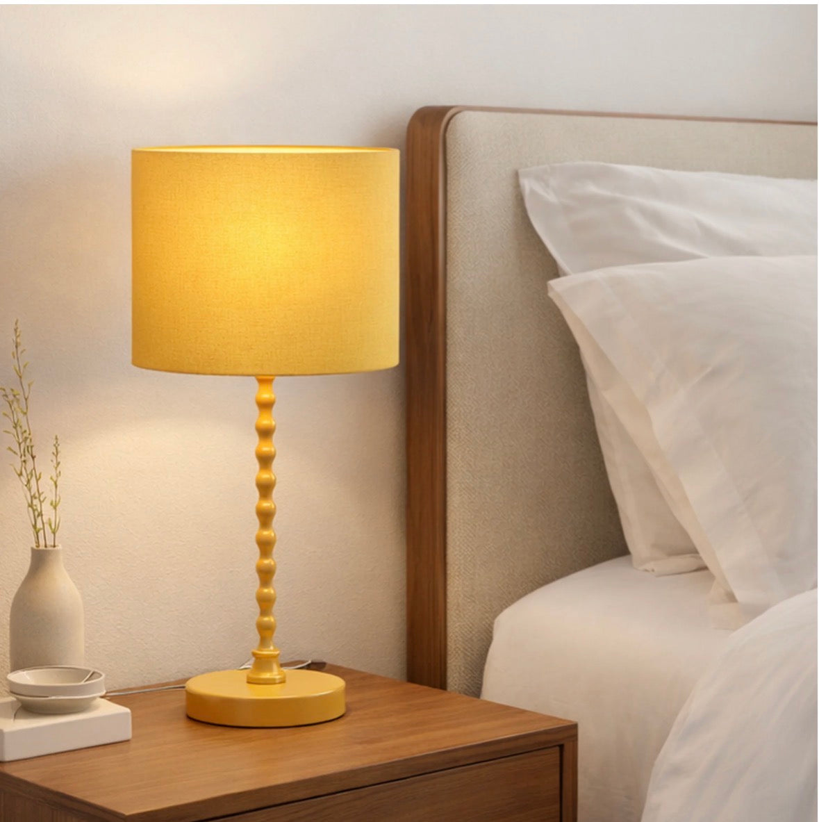 The Solara ochre linen table lamp unlit on a bedside table – full view