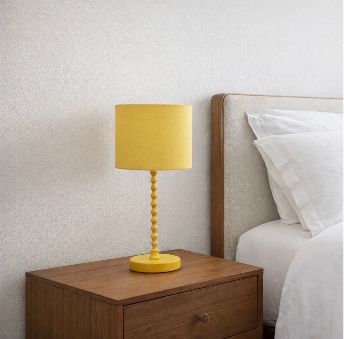 The Solara gold table lamp styled on a live-edge coffee table in a living room