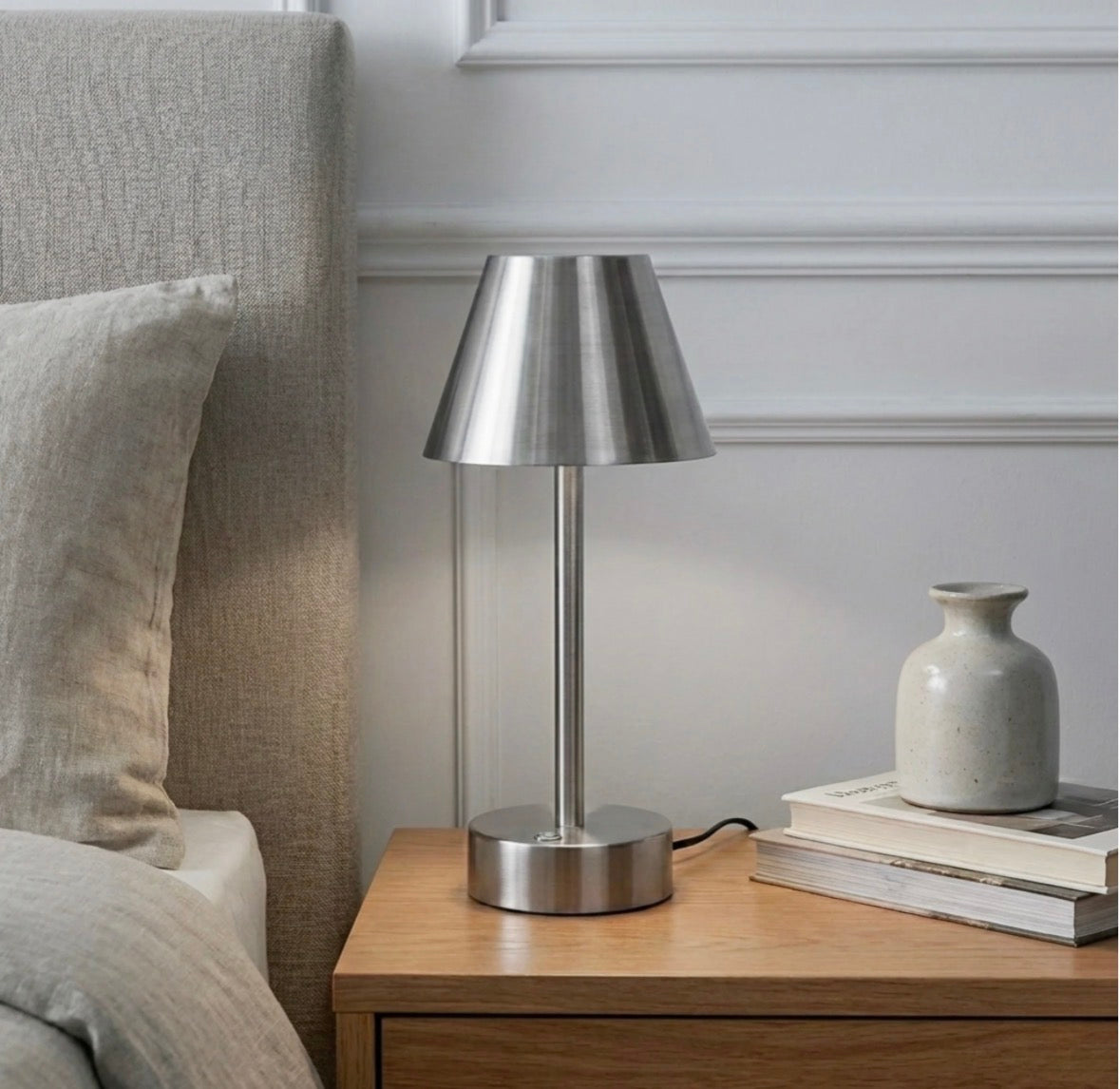 The Lumière brushed nickel cordless LED table lamp unlit on a wooden nightstand