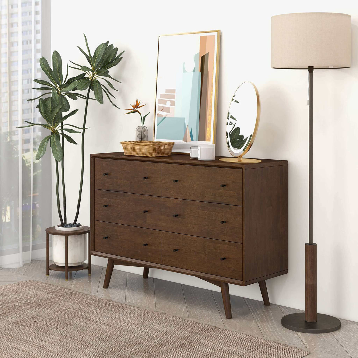 The Amara walnut dresser styled beside a floor lamp